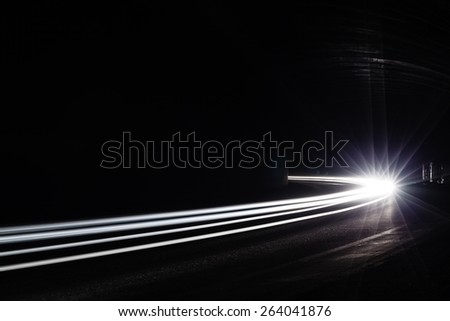 Light tralight trails in tunnel. Art image. Long exposure photo taken in a tunnel.