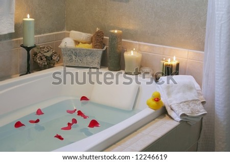 A relaxing candlelit bath with rose petals and a a rubber duck. Low lighting since bathroom was only lit with candles to create relaxing atmosphere.