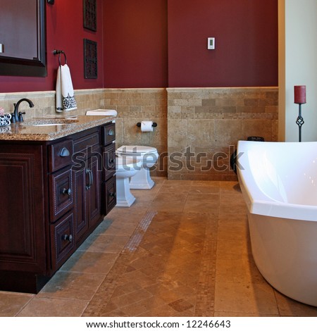 A luxury bathroom interior complete with granite and beautiful tiled floors and walls.