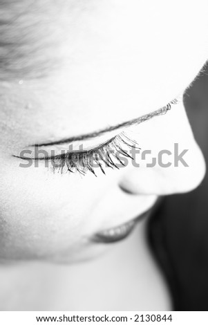 Close Up of gothic girl staring down focus on her eye lashes.