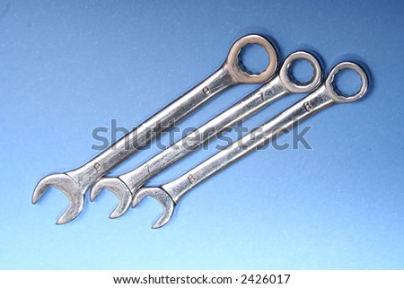 Three spanners on a blue background