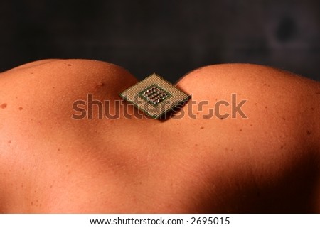 Close up of a male models back in a strange pose with a computer CPU (Processor)