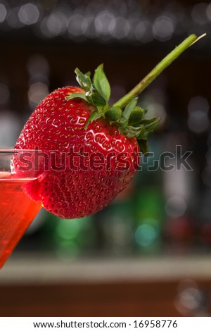 Strawberry on a Martini glass at a bar.