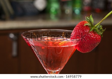 Strawberry on a Martini glass at a bar.