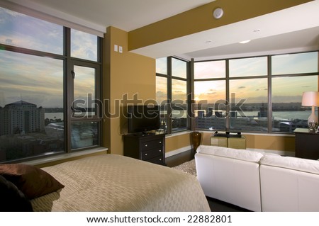 Interior of a High Rise Condo at Sunset with a bed and couch in the foreground