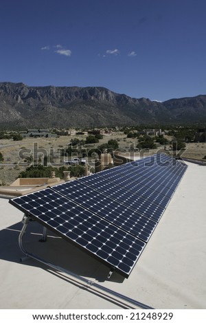 solar panel array against a mountain backdrop