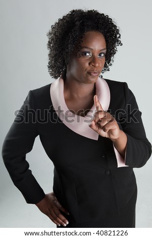 Stern african-american woman shaking her finger at camera.
