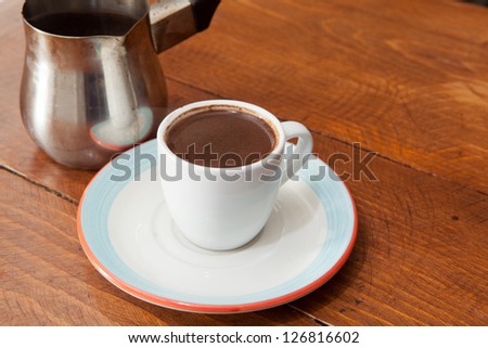 Demitasse cup of rich Turkish coffee, black with a carafe.