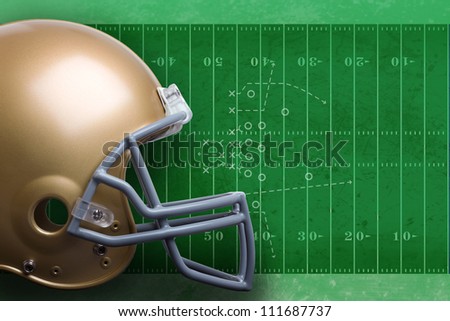 Gold football helmet against green football field with diagram