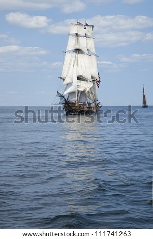Tall ship sailing on blue waters