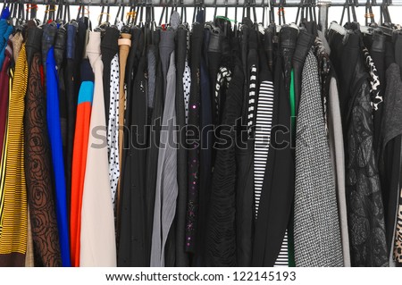 Variety of casual fashion clothing hanging on hangers