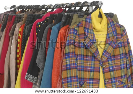Variety of casual female coat with clothes hanging on clothes rack