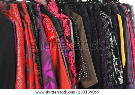 fashion female clothing hanging on hangers background