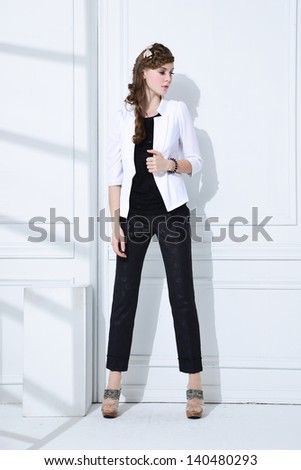 full-length portrait of fashion model standing posing in studio