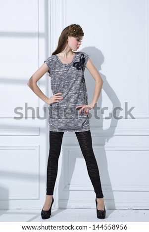full-length portrait of fashion model standing posing in studio