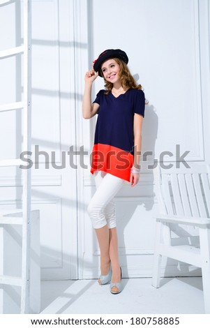 Full body portrait of fashion model with chair posing