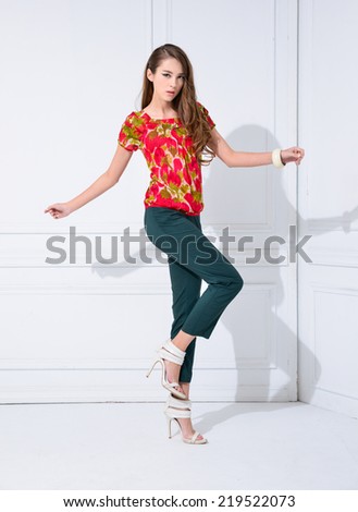 Full length young fashion model posing standing