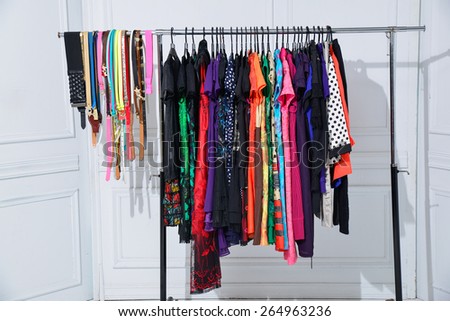 casual fashion clothing with belt on hangers in studio