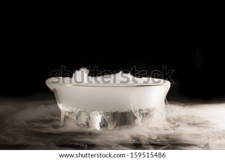 A piece of dry ice dropped into the water. Listed effect boiling of water caused by the transition from a solid state to a gaseous ice