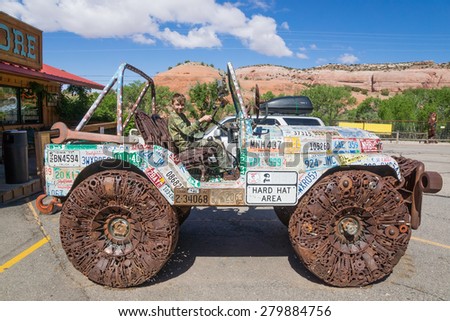 Moab,  Utah/US - MAY 17,2015; A child in a car decorated with american license marks the various states and different scrap