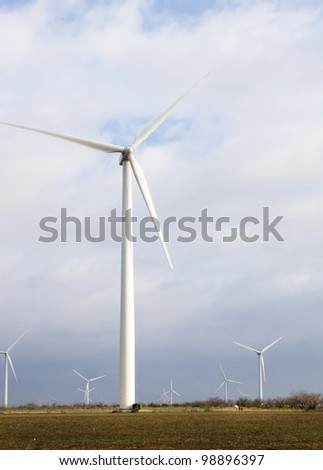 Windmills (wind power) and two horses. Comparison of the size