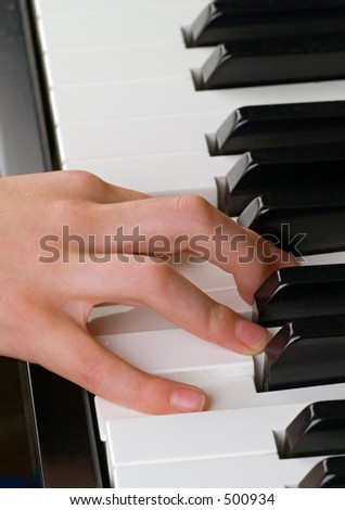 playing the piano, a child\'s right hand