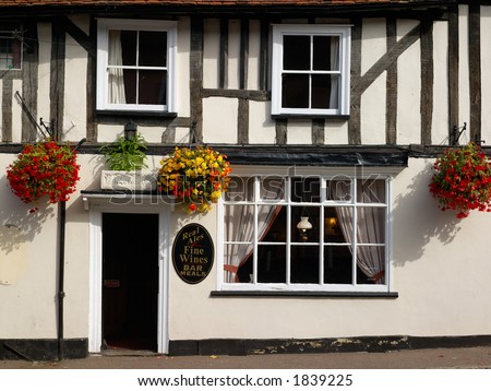 Traditional old English pub external detail, with hanging baskets and warm welcome