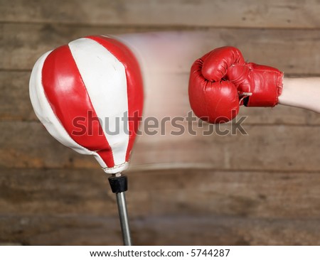 Punching an old grungy punch bag.  Movement effect genuine through multiple exposure.  Shallow focus