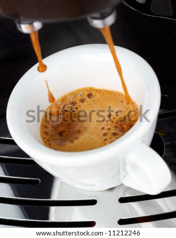 Fresh steaming espresso coffee being made
