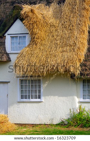 New thatched roof being applied to an English cottage