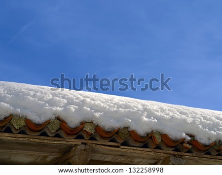 roof with snow on blue sky background