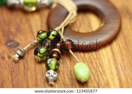 Colorful beads necklace on wooden background