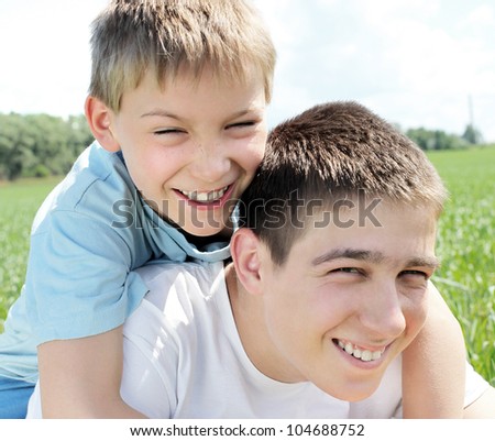 happy brothers in the summer field