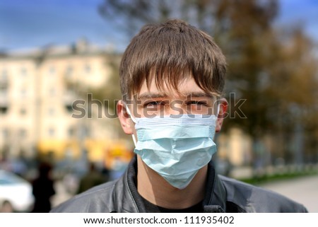 teenager in the flu mask on the street
