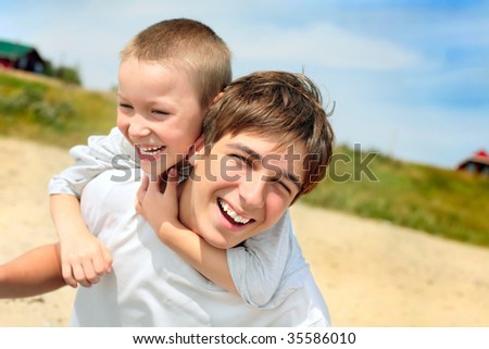 stock photo happy teenager and kid on the beach