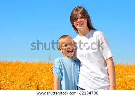 happy brother and sister in the wheat field