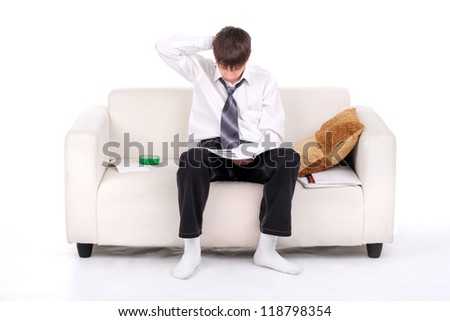 Teenager reads the book on the Sofa. Isolated on the white
