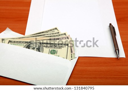 Envelope with a Money and Empty Paper for Text on the Wooden Table