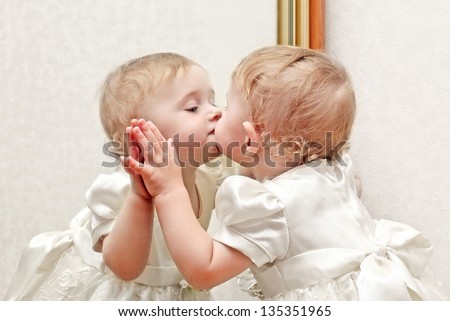 Cute Baby Kissing a Mirror with oneself Reflection