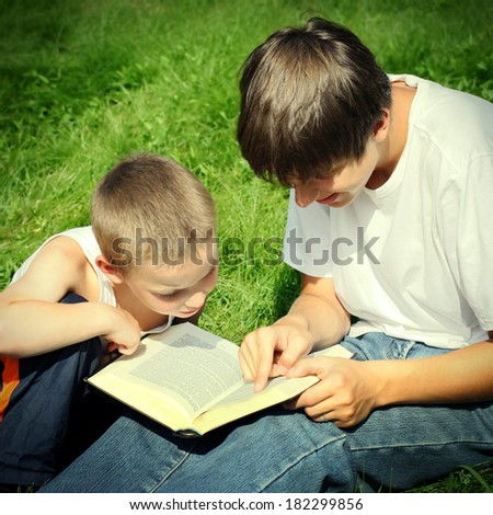 Vintage photo of The Teenager reads the Book to the Child