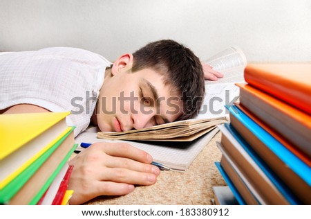 Tired Teenager sleeps after Learning on the Sofa with the Books
