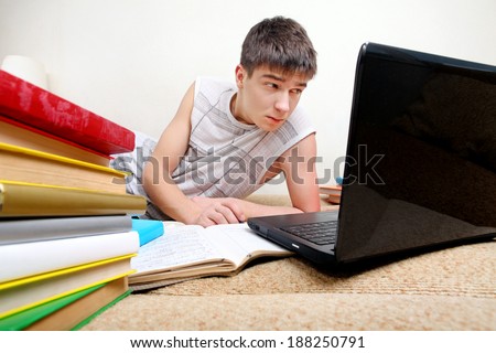 Annoyed Teenager doing Homework at the Home
