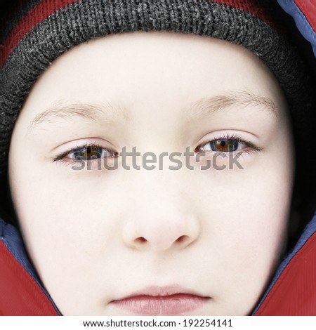 Portrait of Sad Kid Face in the Winter Closeup