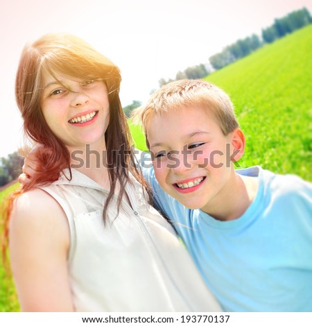 Happy Brother and Sister Portrait at the Summer Field