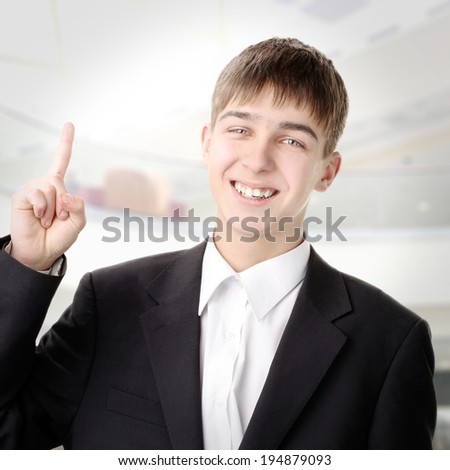 Cheerful Teenager pointing with Finger up