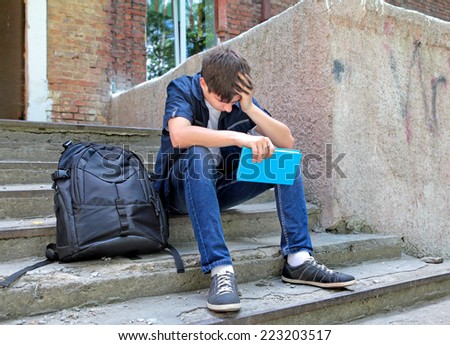 Sad Student with the Book on the landing steps