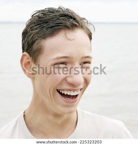 Cheerful Teenager laughing at the Seaside
