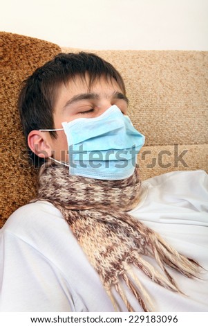 Sick Teenager in Flu Mask on the Sofa at the Home