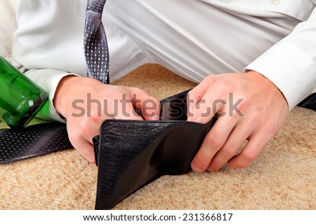 Person Checking Empty Wallet after Party on the Sofa closeup