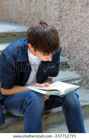 Teenager read the Book on the landing steps